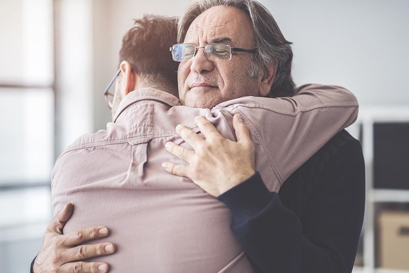 Son hugs his own father